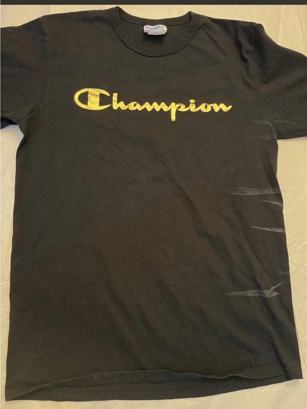 Black Champion T-shirt with yellow logo, size M